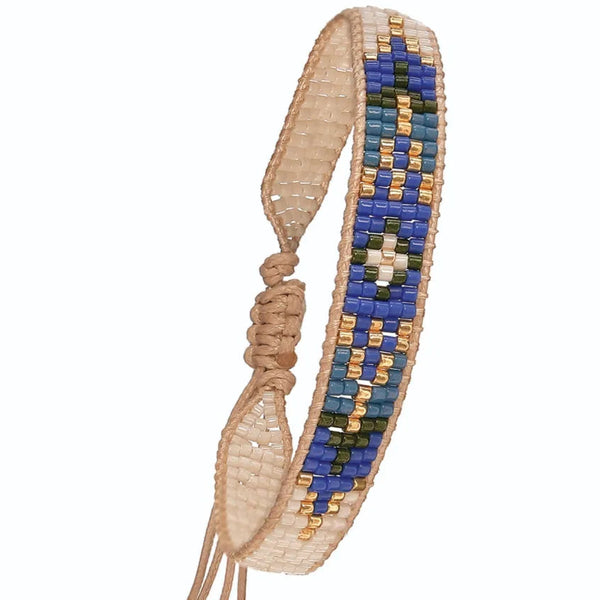 Beaded bracelet with blue and gold pattern on a white background