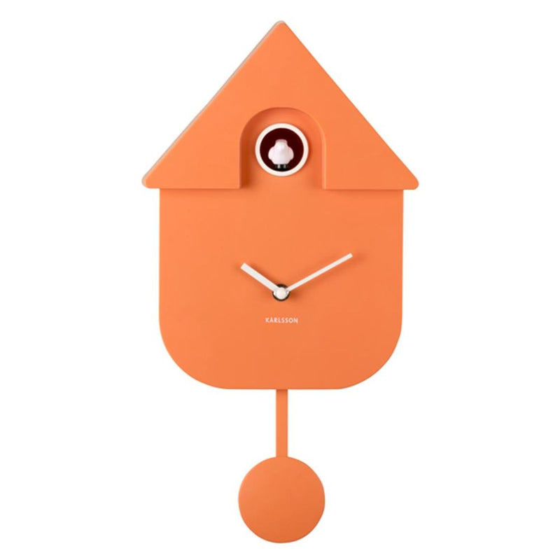 An orange house-shaped cuckoo clock with white hands and a small visible cuckoo eye, photographed against a plain white background.