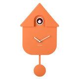 An orange house-shaped cuckoo clock with white hands and a small visible cuckoo eye, photographed against a plain white background.