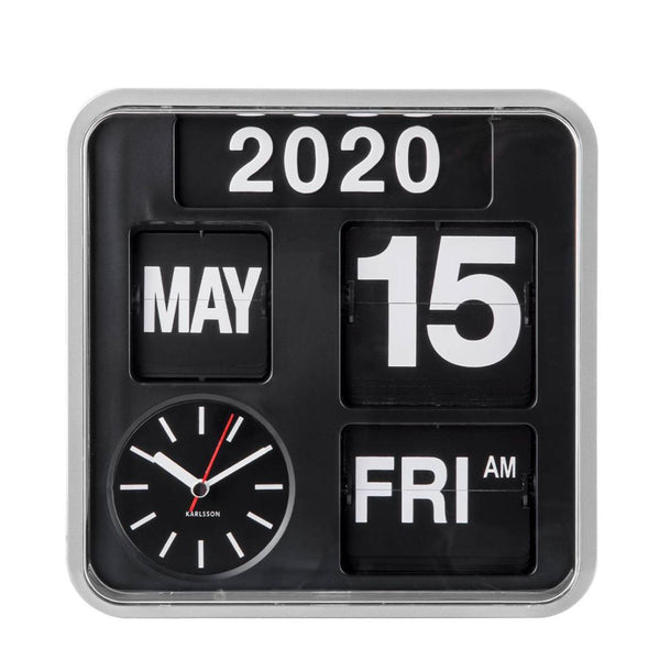 A square black flip-flap calendar clock with a silver-toned frame, displaying the year 2020, the date 15, the month MAY, the day FRI, and AM. A circular black dial with white hands and a red second hand is visible in the lower left.