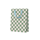 Checkered paper bag with green and white pattern and blue handles on a white background
