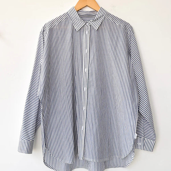 Striped shirt on a hanger against a white background