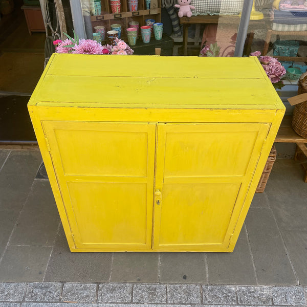 Large vintage yellow painted cupboard top view