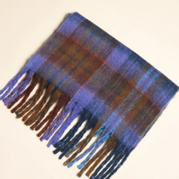Plaid scarf with fringes on a beige background