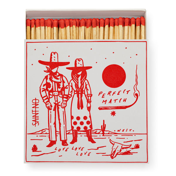 Matchbox with cowboy and cowgirl design and 'Perfect Match' text on a white background