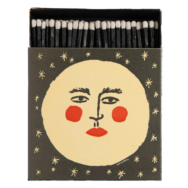 Matches with a face design on the cover against a black background