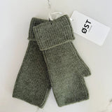 Pair of green fingerless gloves with a visible brand tag on a white background