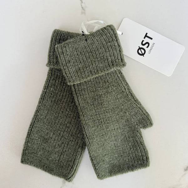 Pair of green fingerless gloves with a visible brand tag on a white background