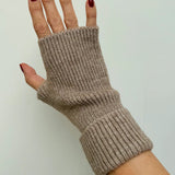 Beige knitted fingerless glove on a neutral background
