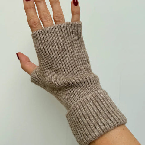 Beige knitted fingerless glove on a neutral background