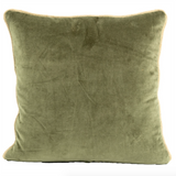 Green velvet pillow on a white background