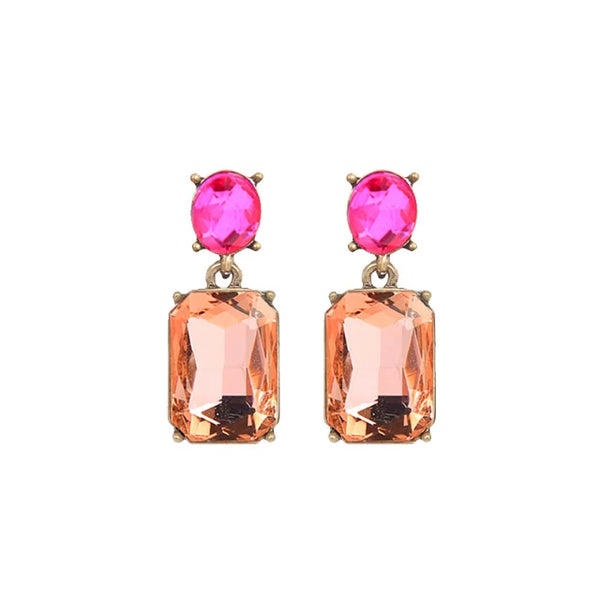 A pair of gold-tone drop earrings featuring a vibrant pink oval gemstone at the top and a peach-colored rectangular emerald-cut gemstone below, set against a plain white background.