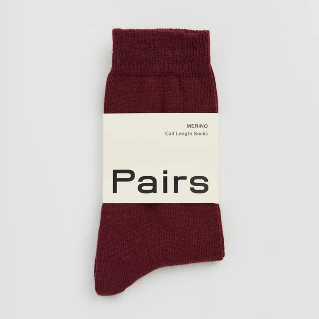 Maroon sock with 'Pairs' label on a light gray background