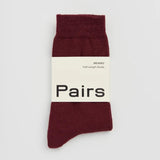 Maroon sock with 'Pairs' label on a light gray background