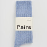Blue sock with 'Pairs' label on a light gray background