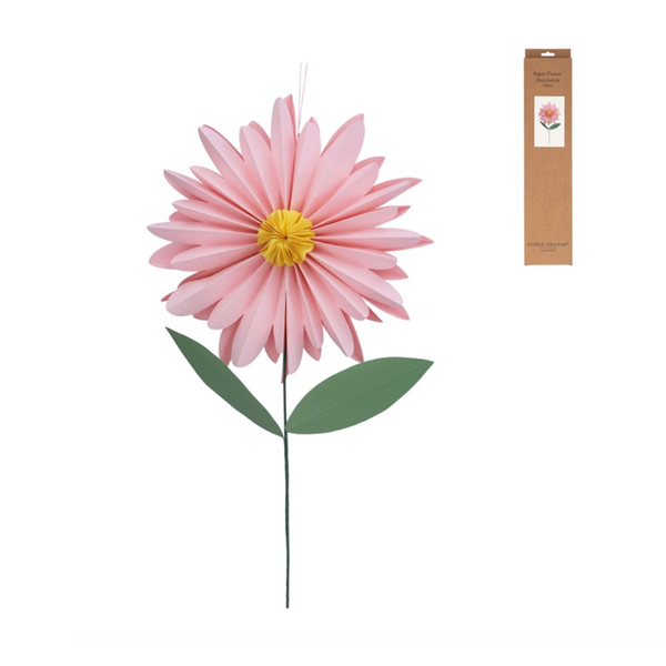 Pink artificial flower with green leaves on a white background