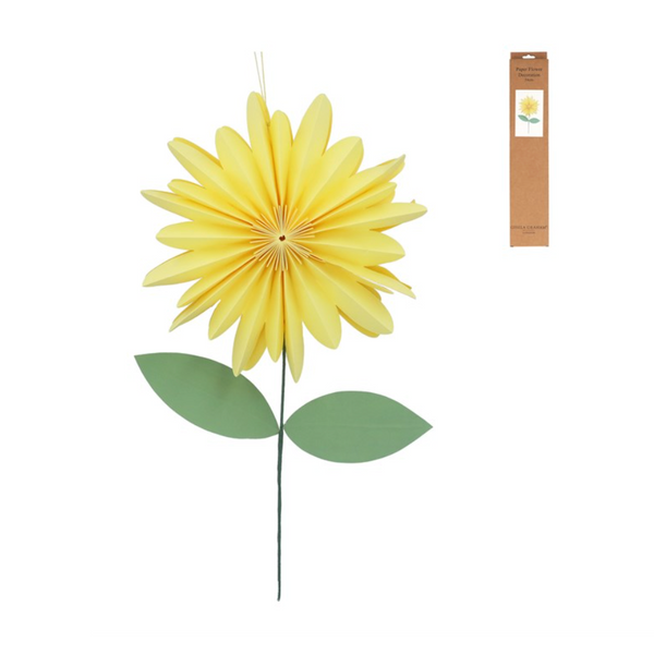 Yellow paper flower with green leaves on a white background