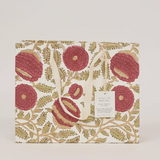 A square gift bag or tote with a cream background and an intricate botanical pattern featuring large dusty rose-red flowers and olive-green leaves. It has two cream canvas handles and a small white paper label on the front with the brand name 'papyr mitaki'.