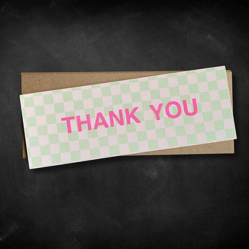 Checkered card with 'THANK YOU' in pink on a black background