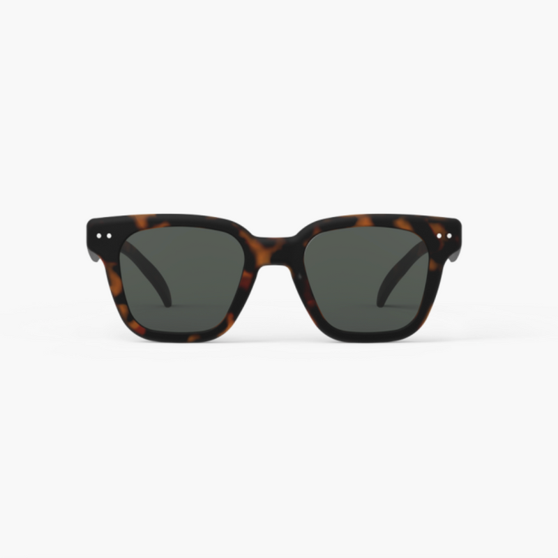 Sunglasses with tortoiseshell frame and dark lenses on a white background