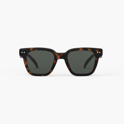 Sunglasses with tortoiseshell frame and dark lenses on a white background
