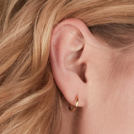 Rachel Jackson Huggie Hoops - Gold plated on person