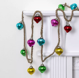 Colorful heart-shaped ornaments on a rope against a white background