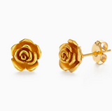 Gold rose-shaped earrings on a white background