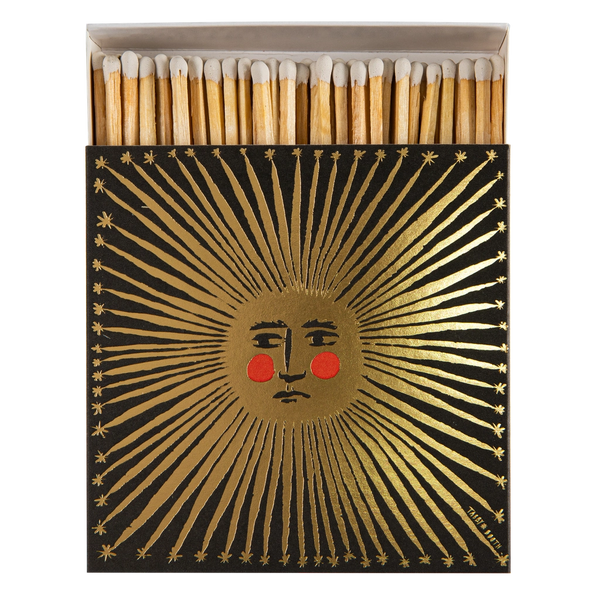 Safety matches with a decorative box featuring a sun design on a white background