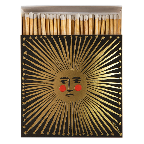 Safety matches with a decorative box featuring a sun design on a white background