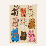 Set of colorful cat-shaped decorations on a beige background