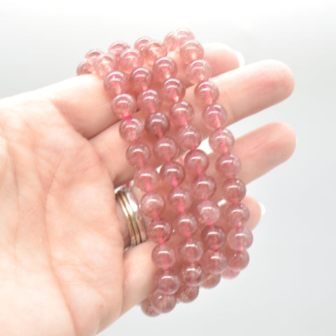 files/Semi_Precious_Gemstone_Round_Beaded_Bracelet_-_Strawberry_Quartz_on_hand.jpg