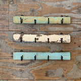 Set of 4 Vintage Hooks on distressed painted wood