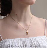 Silk Purse, Sow's Ear Gold Moving Fish Necklace on neck