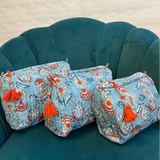  Sky Blue Cotton quilted wash bag with orange and white floral pattern plastic lined on the inside 