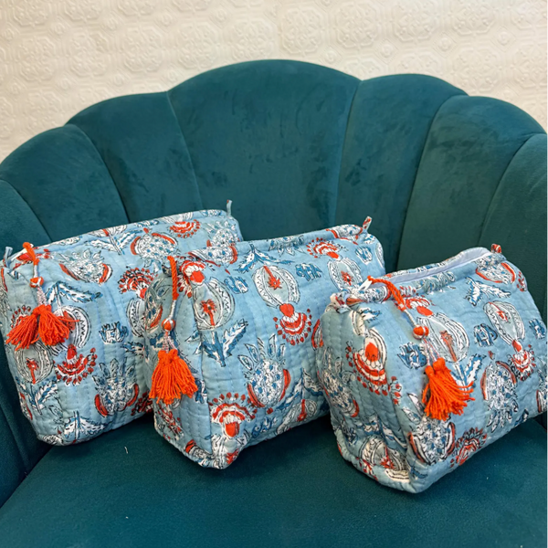  Sky Blue Cotton quilted wash bag with orange and white floral pattern plastic lined on the inside 