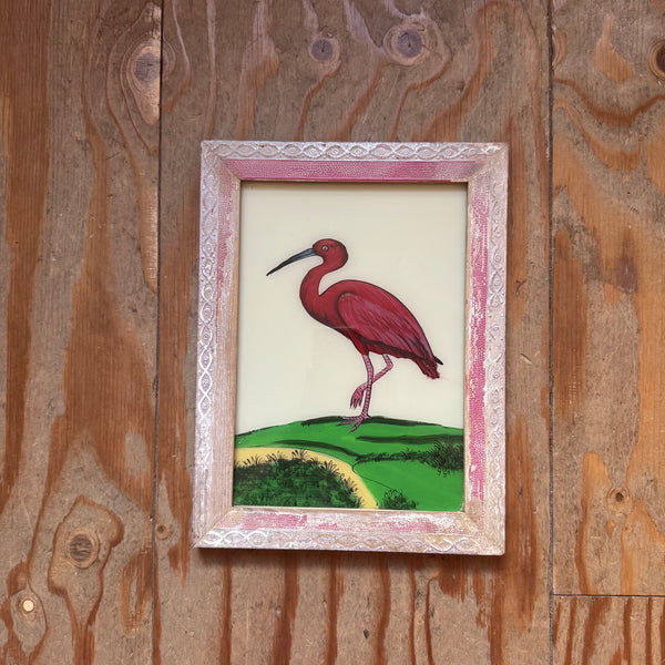 Small framed painting of a red bird on a wooden panel