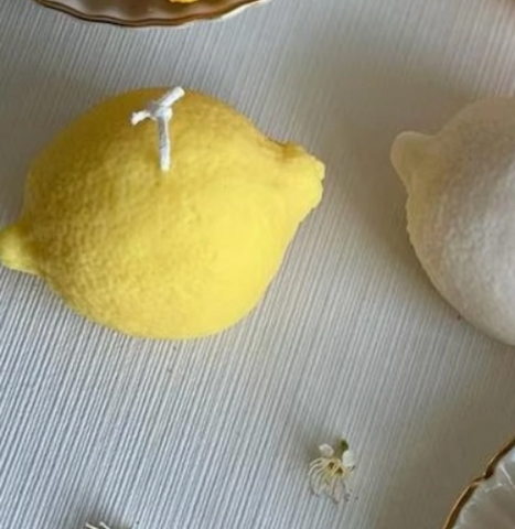 Two lemons on a textured surface with a blurred background
