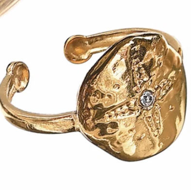 Gold ring with a textured design on a white background