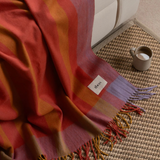 Tbco Lambswool Blanket in Orange Frame Check draped