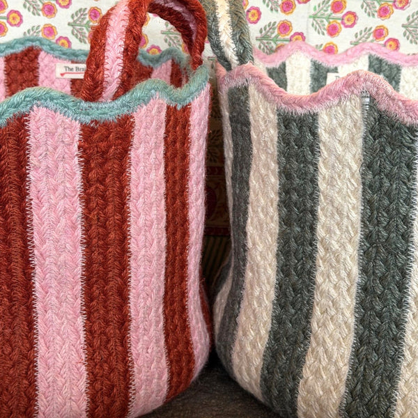 Two striped fabric baskets against a floral-patterned background