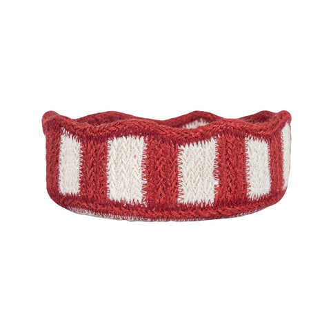 Red and white striped knitted headband on a white background