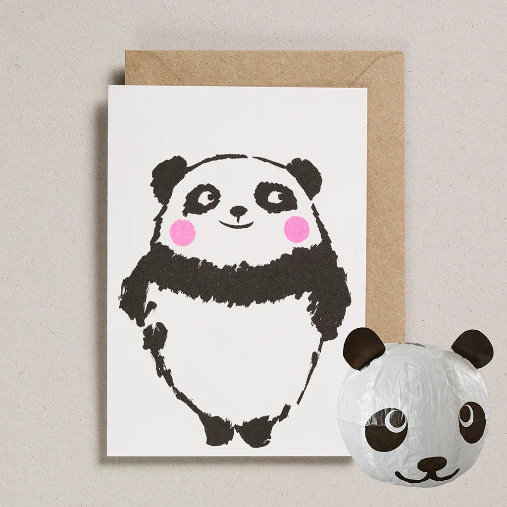 Greeting card with a panda illustration and a small panda-shaped ball on a beige background