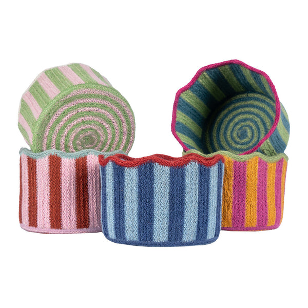 Set of colorful striped fabric containers on a white background