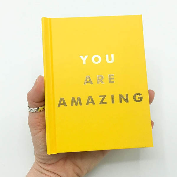 You Are Amazing Quotes and Statements to Make You Feel Empowered in hand