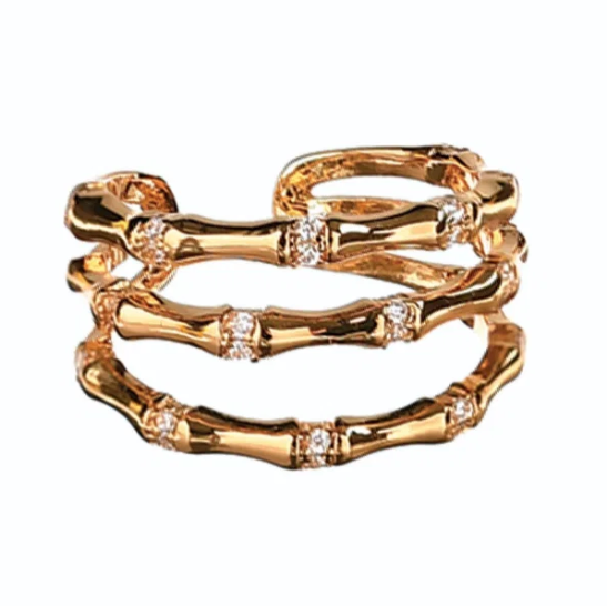 Gold ring with embedded diamonds on a white background