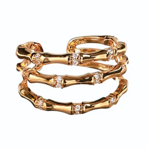 Gold ring with embedded diamonds on a white background