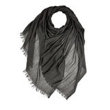 Black scarf with frayed edges on a white background