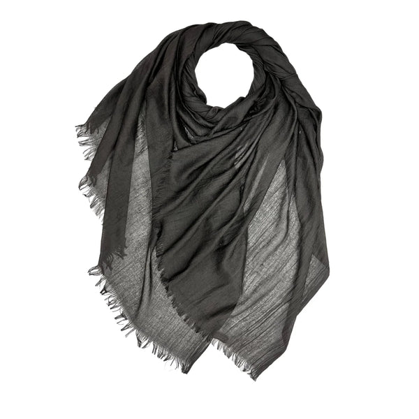 Black scarf with frayed edges on a white background