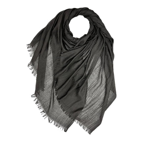 Black scarf with frayed edges on a white background